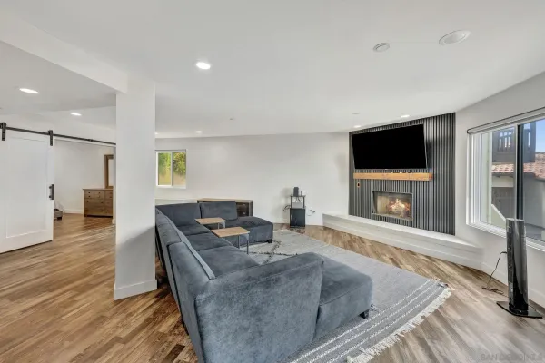 a living room with fireplace furniture and a flat screen tv