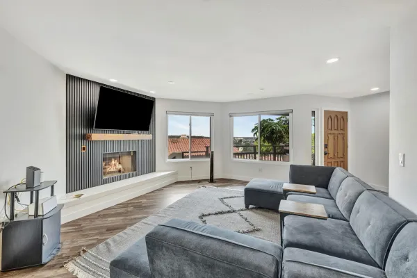 a living room with furniture a fireplace and a flat screen tv