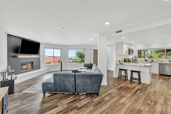 a living room with furniture a flat screen tv and a fireplace