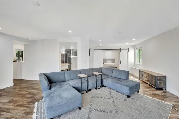 a living room with furniture and a wooden floor