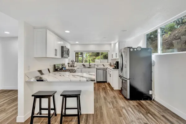 a kitchen with a refrigerator a sink and cabinets