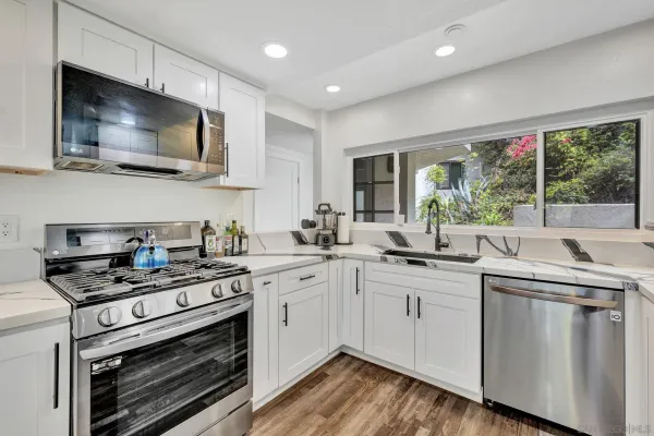 a kitchen with a sink stove and microwave