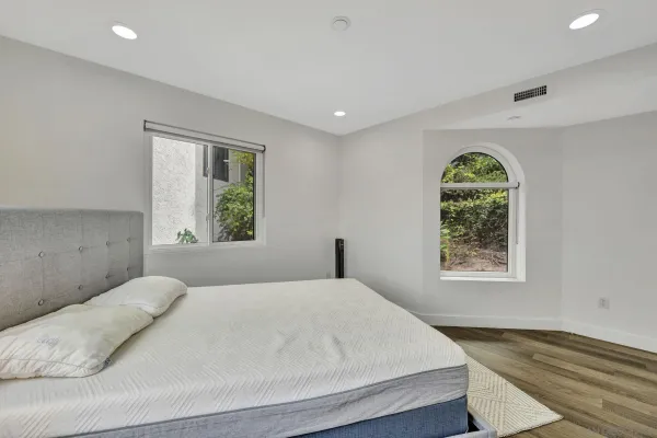 a bedroom with a bed and a window