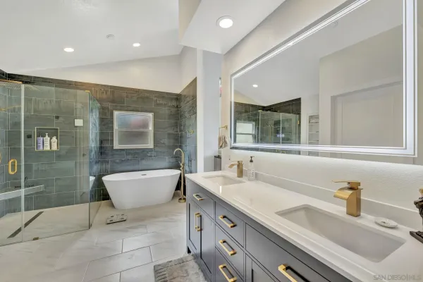 a bathroom with a sink double vanity and a shower