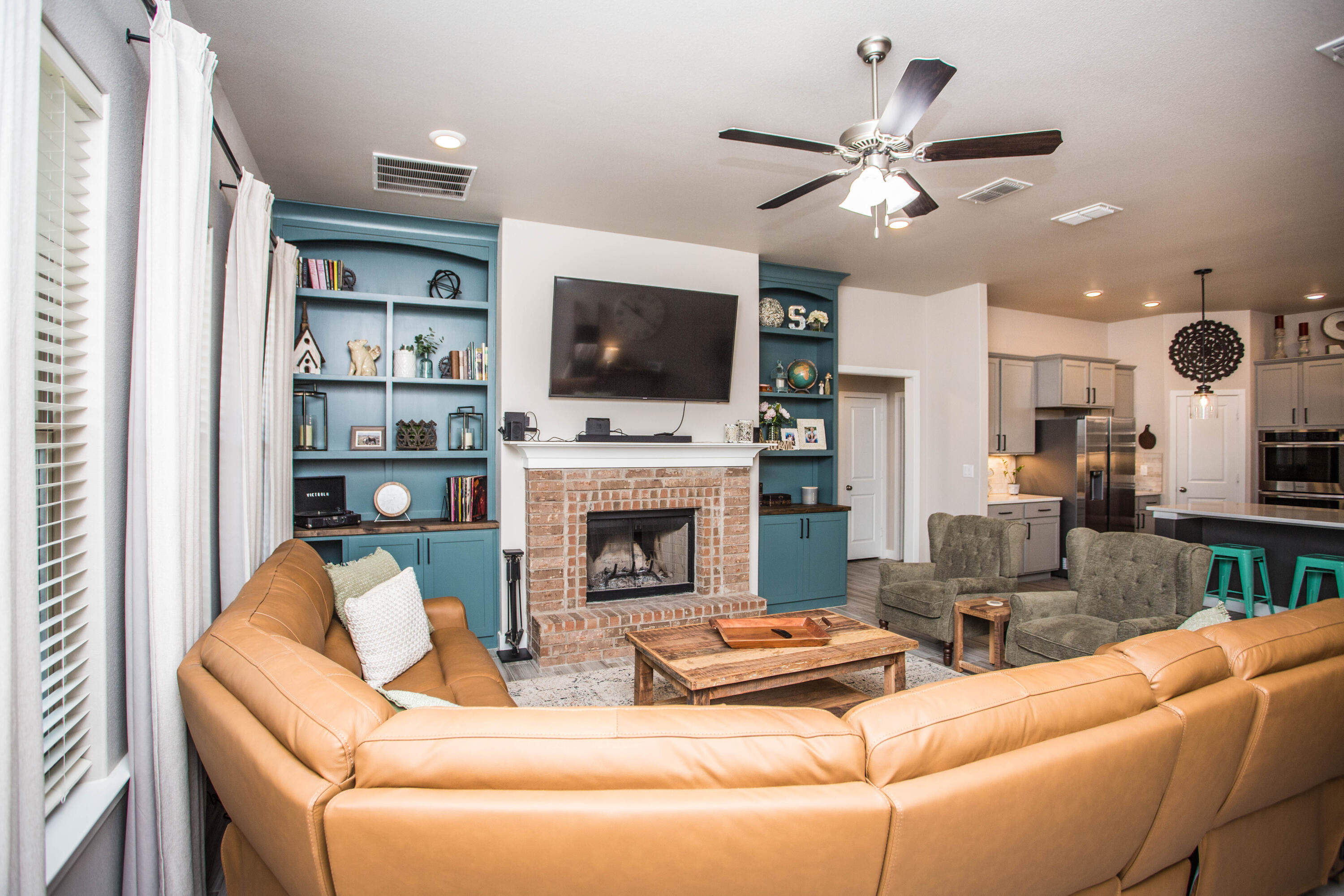 1932 142nd Street Lubbock, TX 79423 - Photo 13 of 38 a living room with furniture a fireplace and a flat screen tv