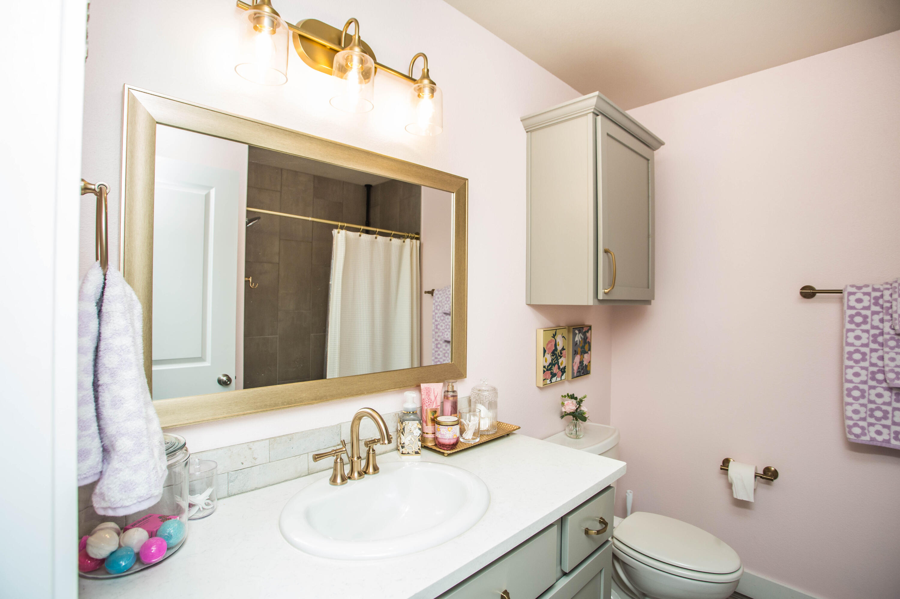 1932 142nd Street Lubbock, TX 79423 - Photo 16 of 38 a bathroom with a sink vanity mirror and toilet