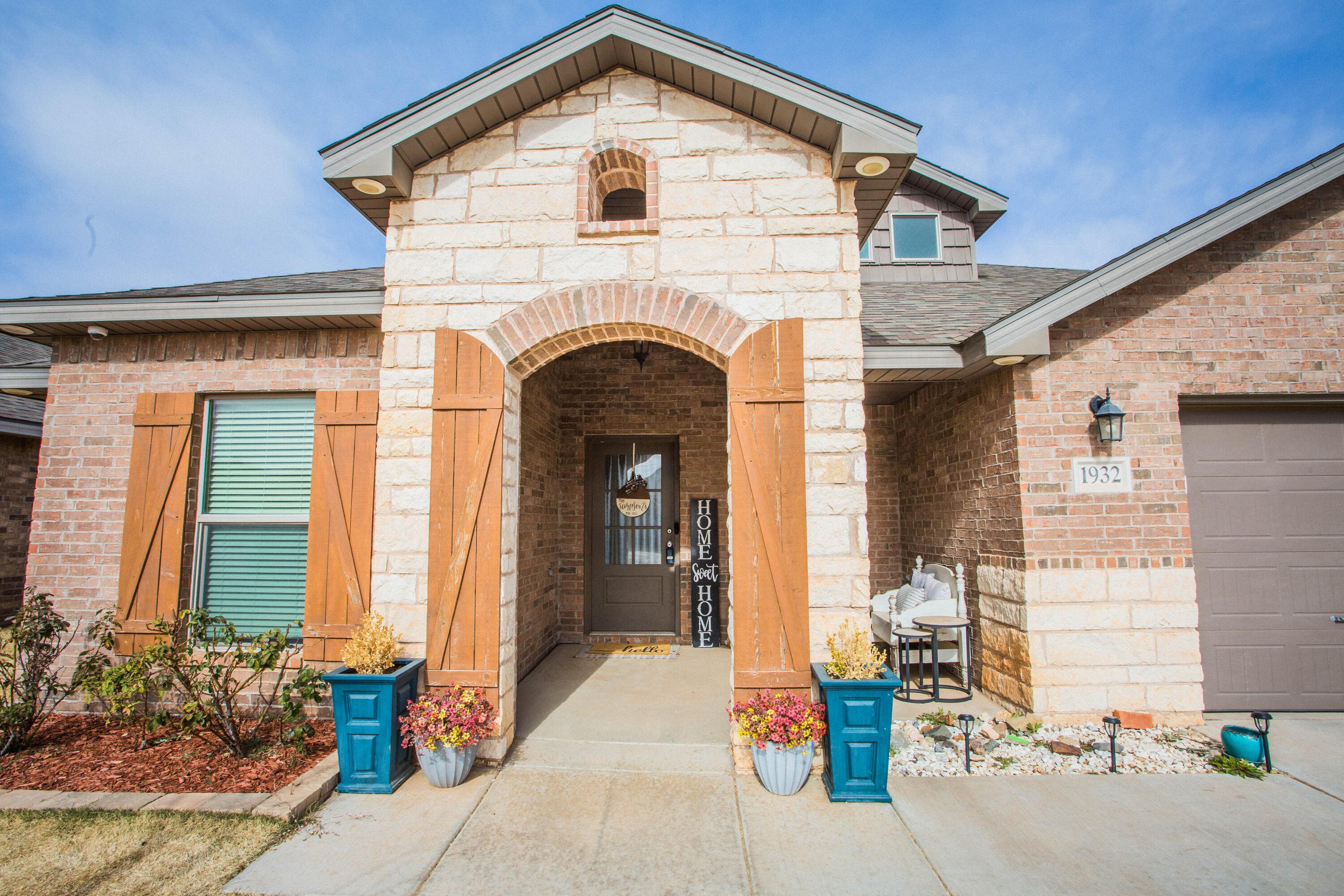 1932 142nd Street Lubbock, TX 79423 - Photo 2 of 38 a front view of a house with a garage
