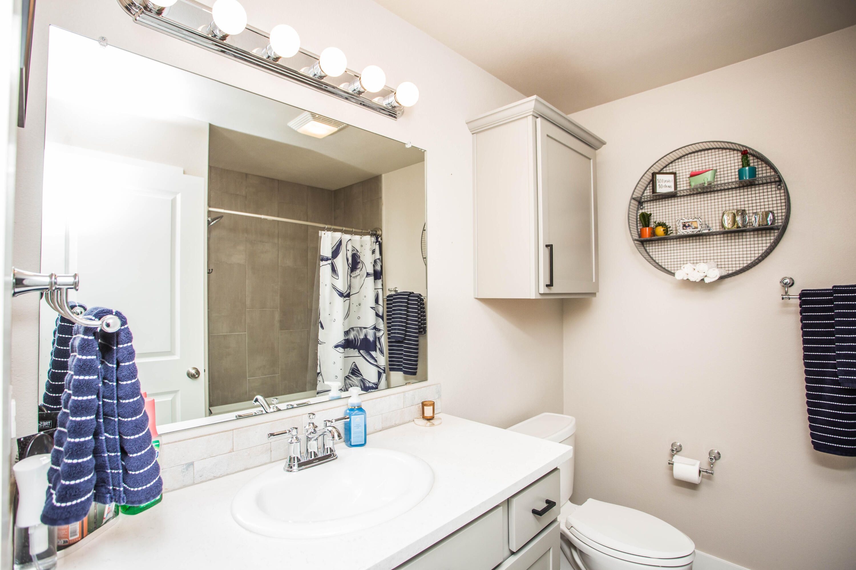1932 142nd Street Lubbock, TX 79423 - Photo 24 of 38 a bathroom with a toilet a sink and a mirror