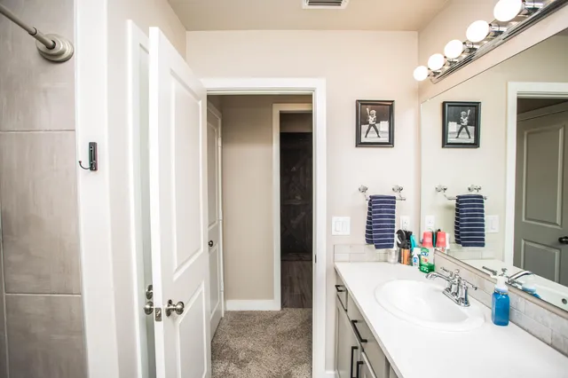 a bathroom with a tub sink and a mirror