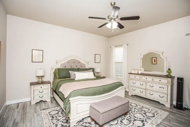 a bedroom with a bed and a dresser