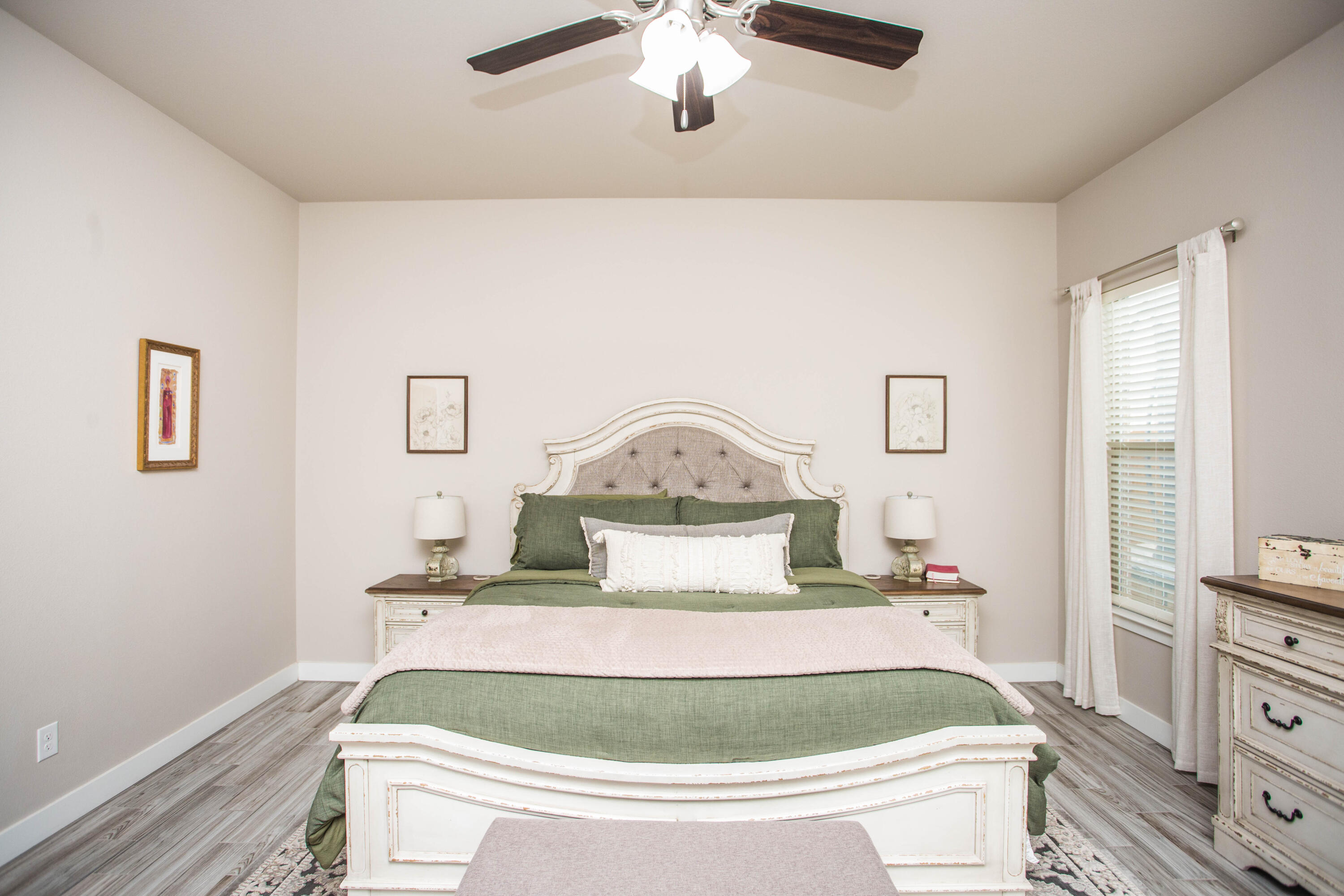 1932 142nd Street Lubbock, TX 79423 - Photo 27 of 38 a bedroom with a bed and a chandelier