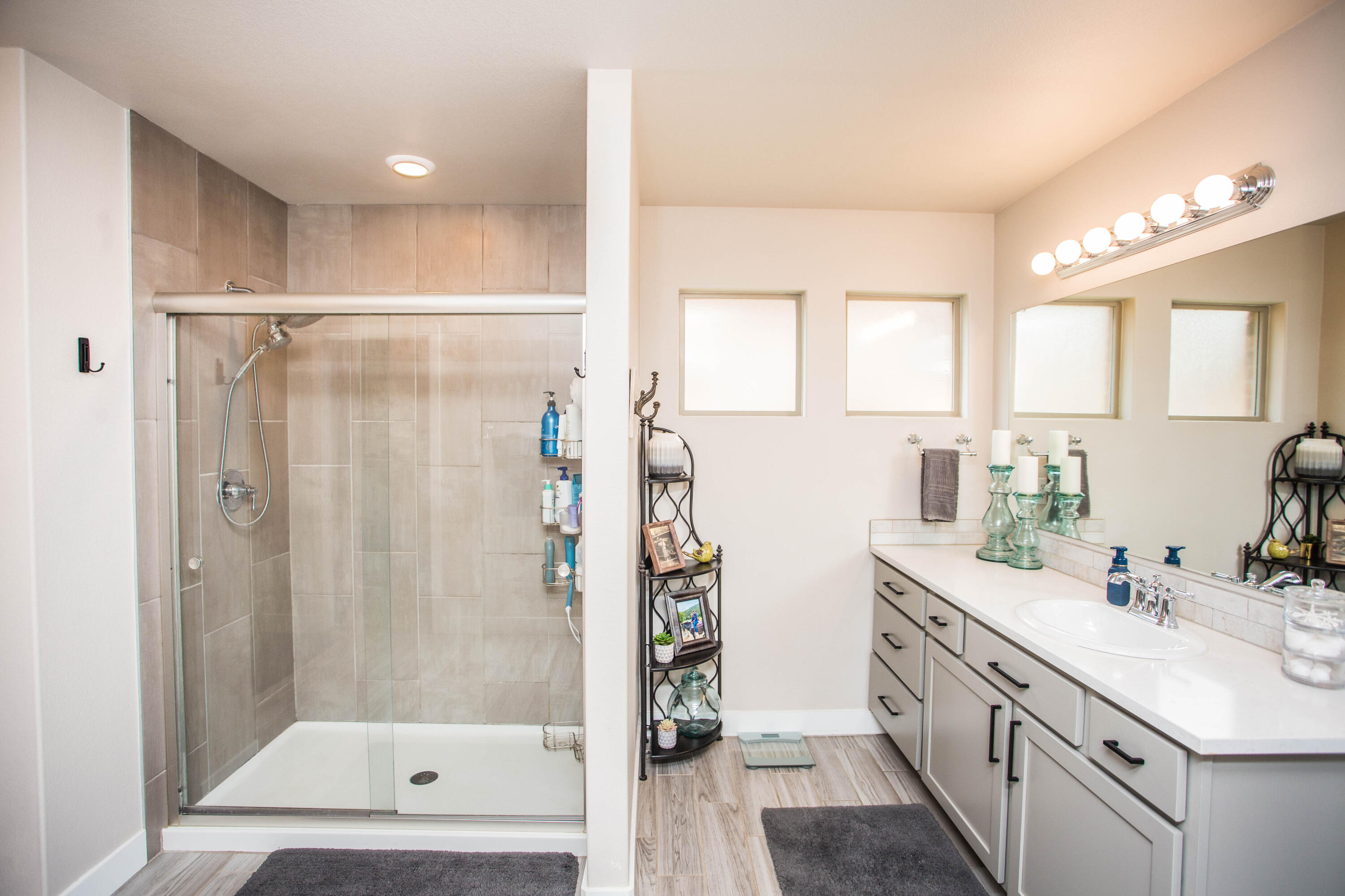 1932 142nd Street Lubbock, TX 79423 - Photo 30 of 38 a bathroom with a shower sink and mirror