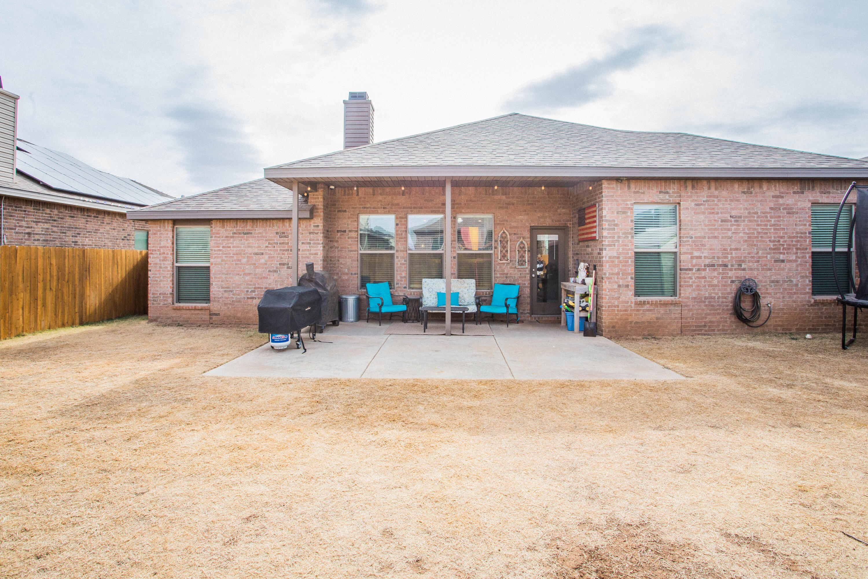 1932 142nd Street Lubbock, TX 79423 - Photo 36 of 38 a view of a house with a backyard and sitting area