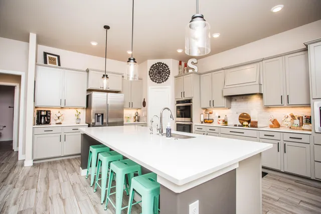 a kitchen with kitchen island a white cabinets and wooden floor