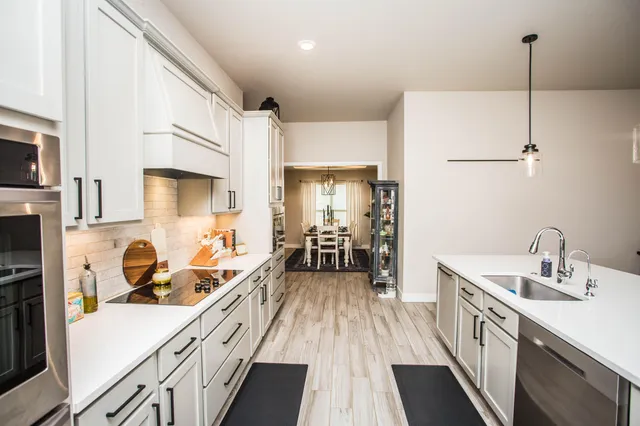 a kitchen with a sink stove and refrigerator