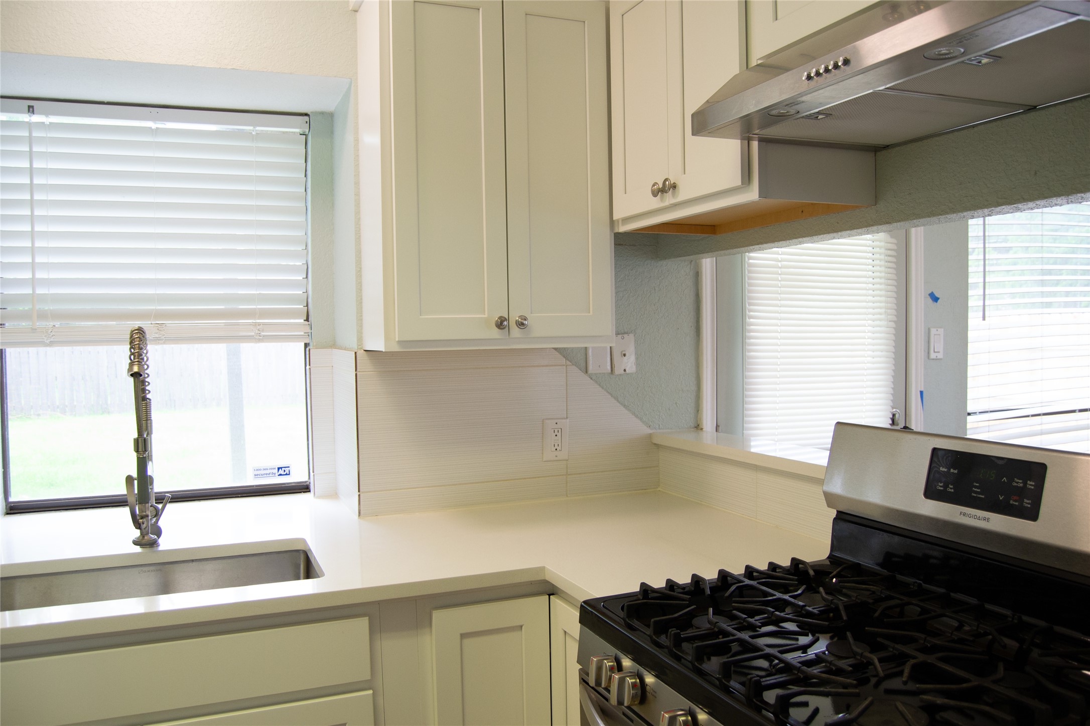 2501 Autrey Drive Leander, TX 78641 - Photo 13 of 27 a kitchen with a sink and a stove next to a window