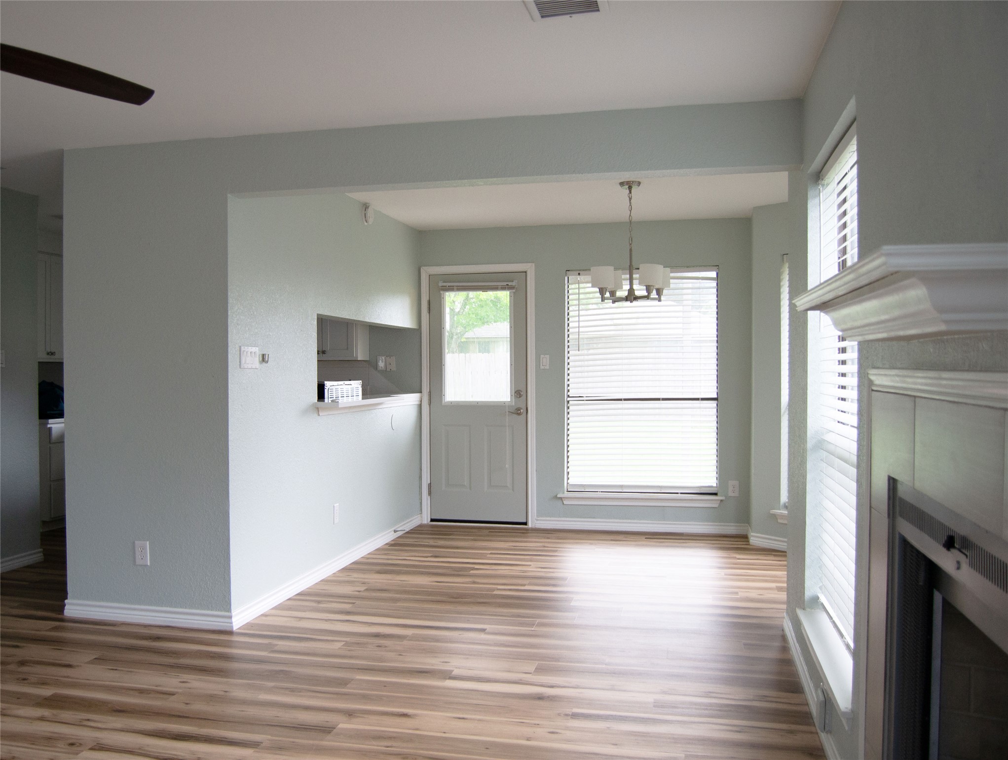 2501 Autrey Drive Leander, TX 78641 - Photo 6 of 27 an empty room with wooden floor and windows