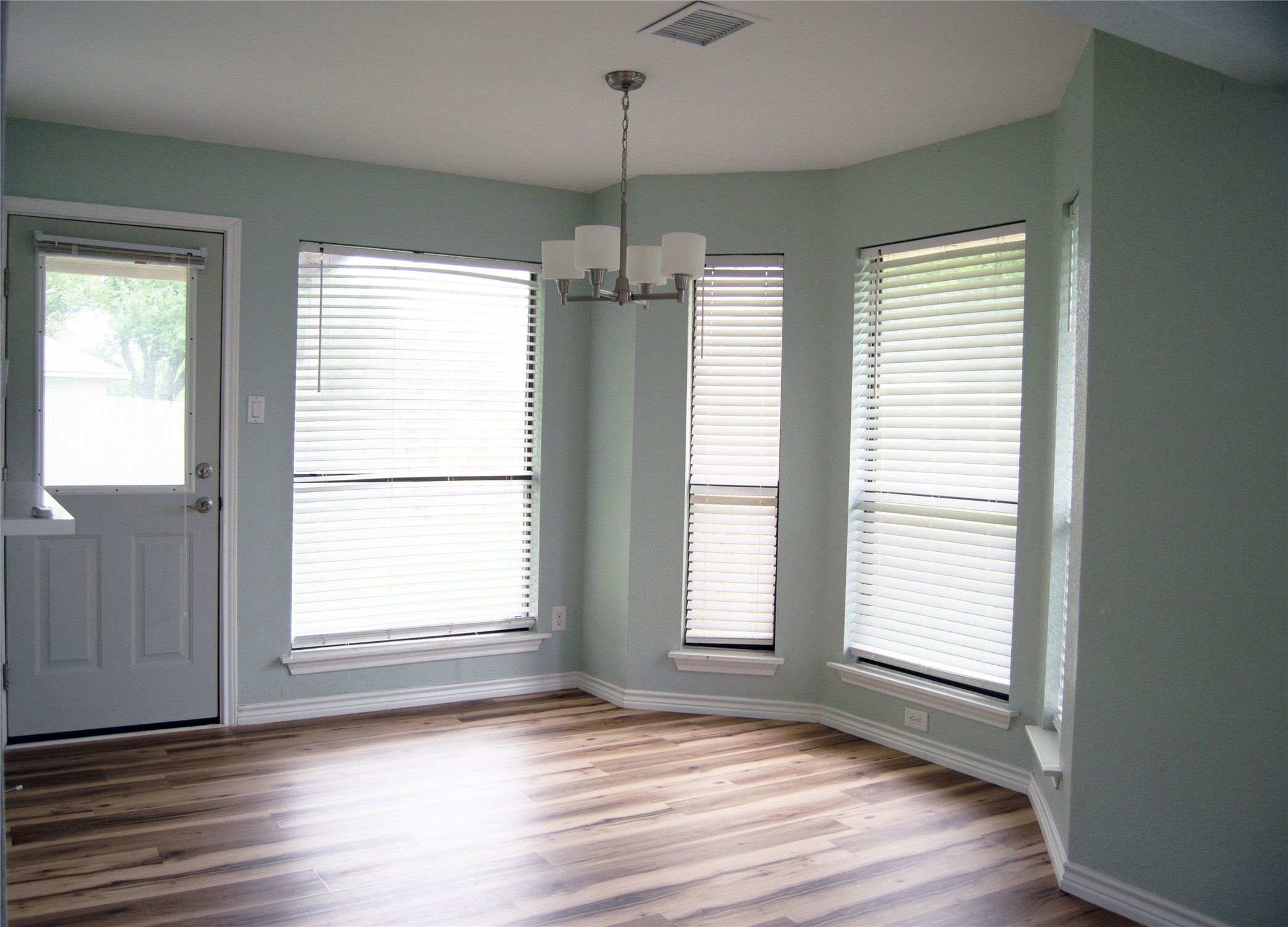 2501 Autrey Drive Leander, TX 78641 - Photo 7 of 27 a view of an empty room with wooden floor and a window