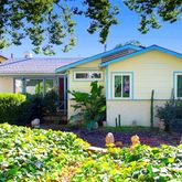 a view of a house with a yard and garden