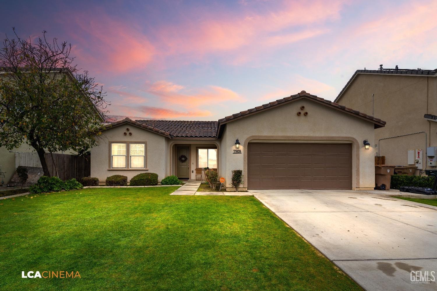 Undisclosed Address Bakersfield, CA 93313 - Photo 1 of 28 a front view of a house with a yard and garage
