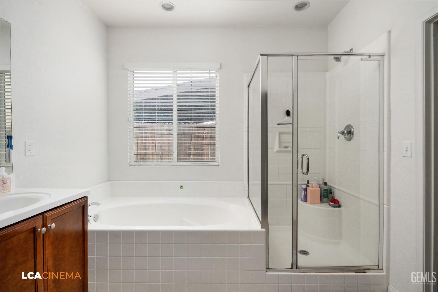 Undisclosed Address Bakersfield, CA 93313 - Photo 18 of 28 a bathroom with a bathtub and a shower
