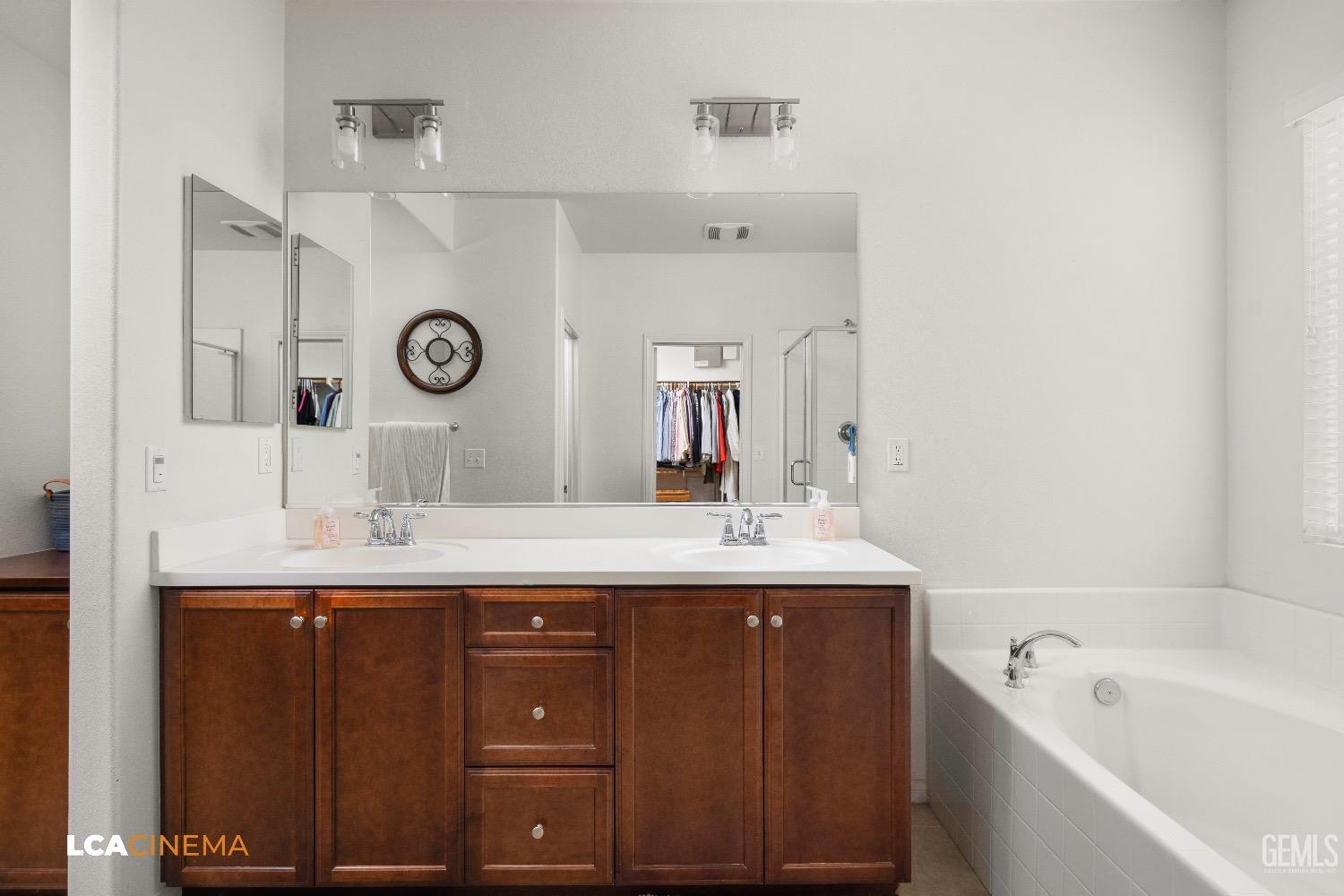 Undisclosed Address Bakersfield, CA 93313 - Photo 19 of 28 a bathroom with a double vanity sink and a mirror