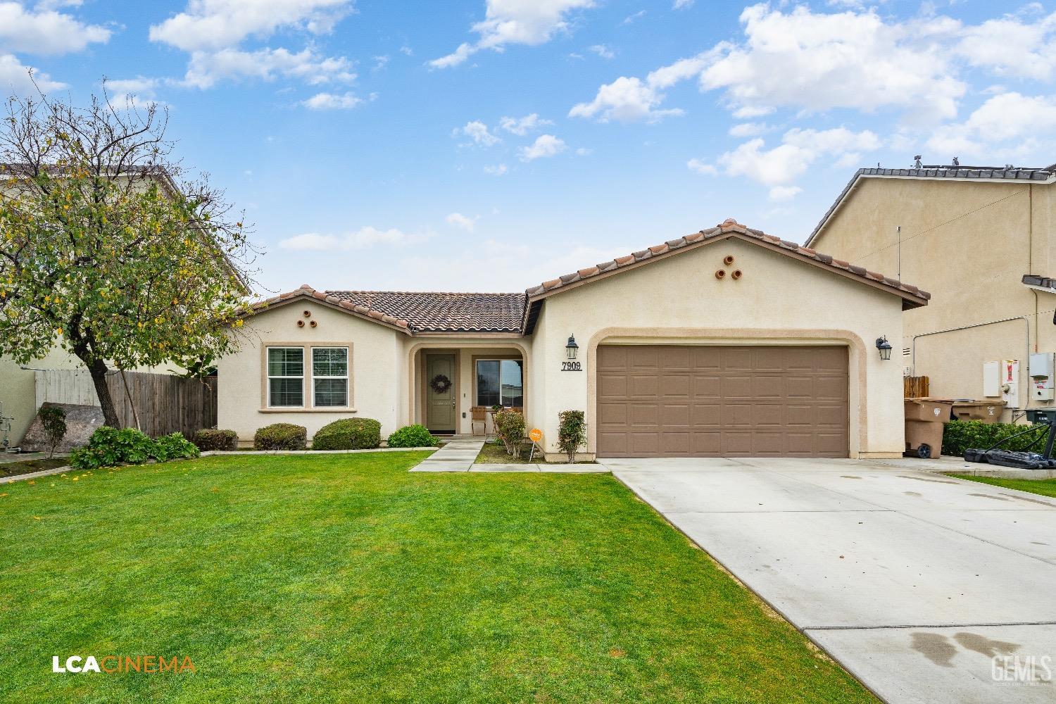 Undisclosed Address Bakersfield, CA 93313 - Photo 2 of 28 a front view of a house with a yard and trees