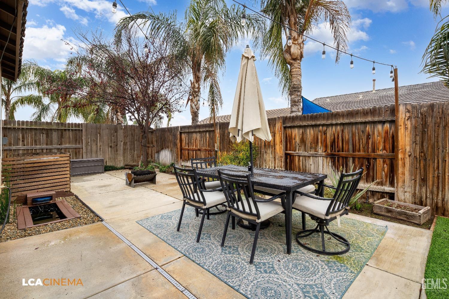 Undisclosed Address Bakersfield, CA 93313 - Photo 27 of 28 a view of backyard with table and chairs and a barbeque with potted plants