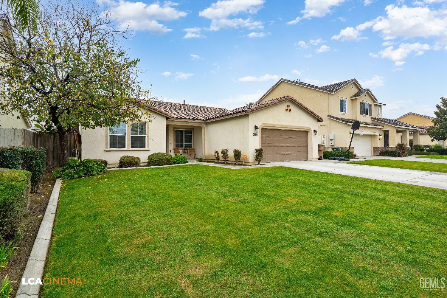 Undisclosed Address Bakersfield, CA 93313 - Photo 3 of 28 a front view of a house with a garden and yard
