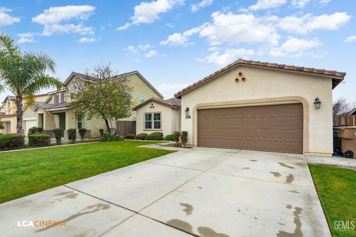 Undisclosed Address Bakersfield, CA 93313 - Photo 4 of 28 a front view of a house with a yard