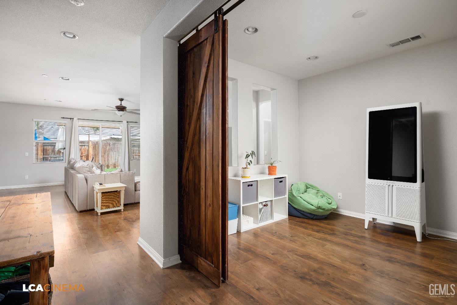 Undisclosed Address Bakersfield, CA 93313 - Photo 6 of 28 a view of living room and dining room with wooden floor