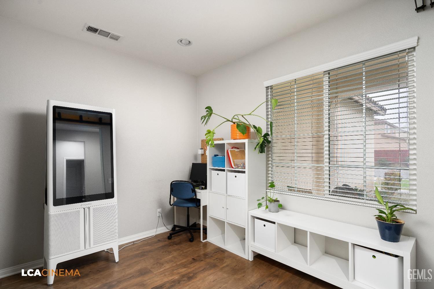 Undisclosed Address Bakersfield, CA 93313 - Photo 7 of 28 a living room with furniture and wooden floor