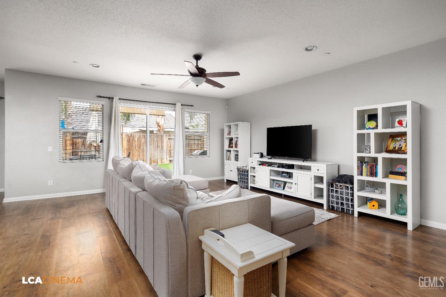 Undisclosed Address Bakersfield, CA 93313 - Photo 10 of 28 a living room with furniture flat screen tv and wooden floor