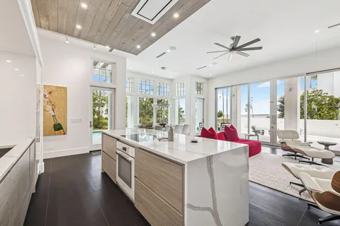 a living room with furniture and a floor to ceiling window