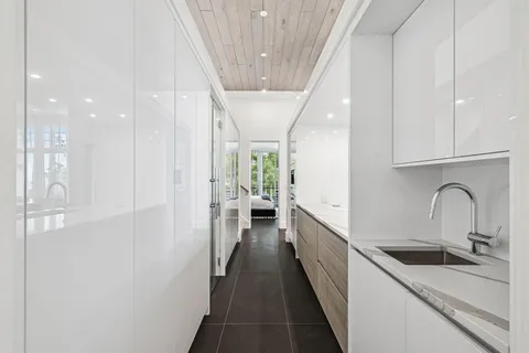 a bathroom with a tub sink and mirror