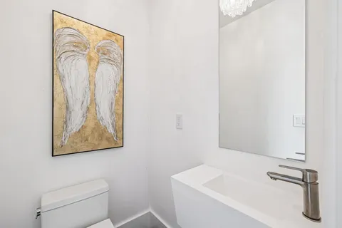 a bedroom with a large bed and a flat tv screen