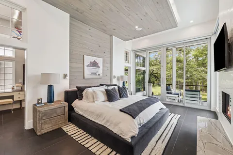 a bedroom with a bed and a flat screen tv