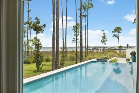 a living room with furniture a flat screen tv and a large window