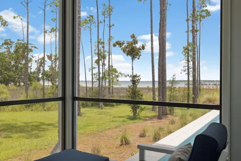 a view of a balcony with a dining table chairs and wooden floor