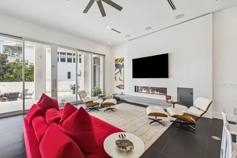 a living room with furniture kitchen view and a flat screen tv