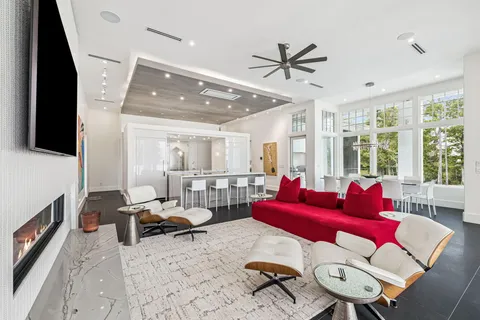 a living room with furniture and large windows