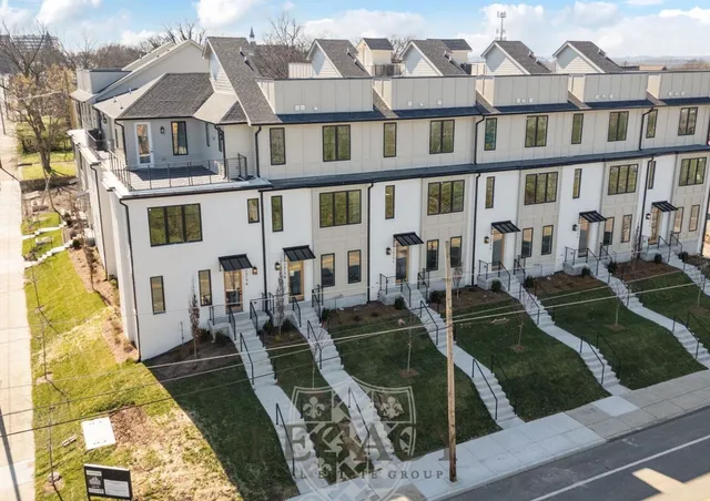 a view of a brick building next to a yard