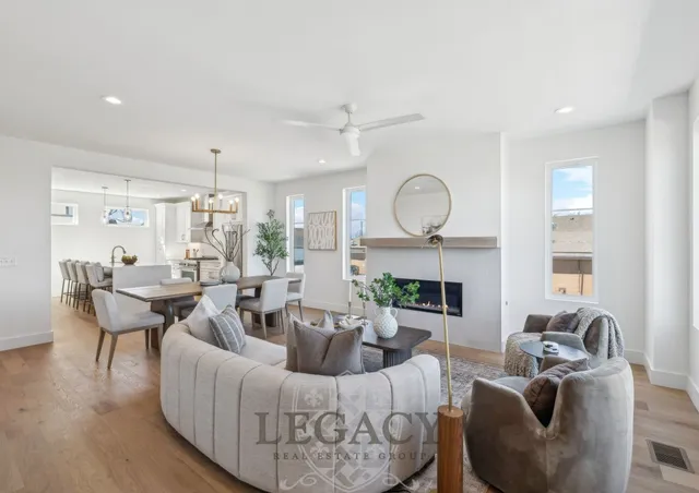 a living room with furniture a fireplace and a large window