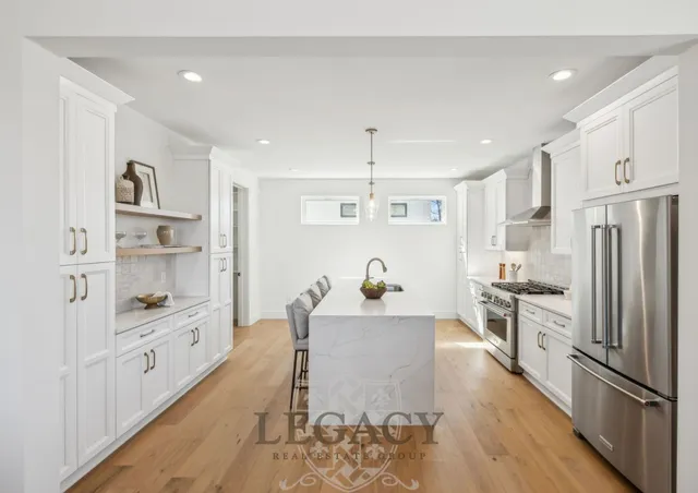 a kitchen with white cabinets and stainless steel appliances