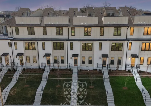 a front view of a residential apartment building with a yard