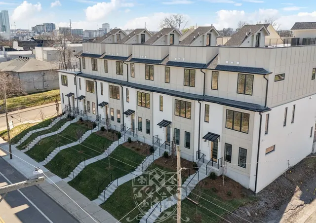 an aerial view of a house with a yard