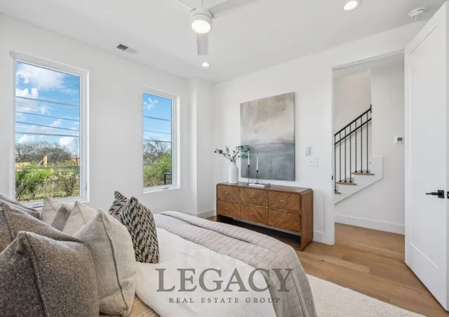 a bedroom with furniture and windows
