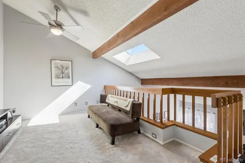 a balcony with furniture and a ceiling fan