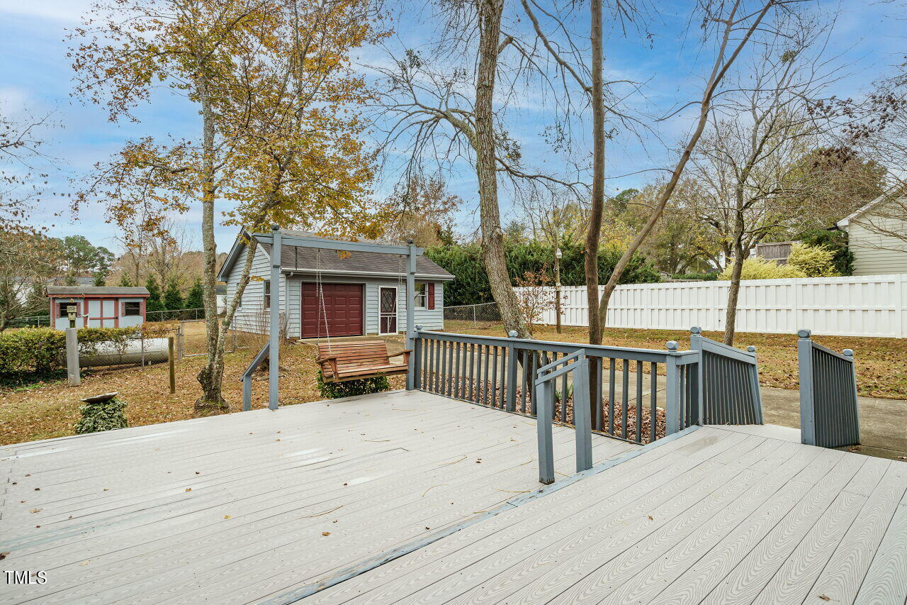 5917 Countryview Lane Raleigh, NC 27606 - Photo 21 of 43 Step outside to the awesome deck, an entertainer's dream come true. This spacious outdoor haven is designed for gatherings, relaxation, and making the most of your outdoor living. Whether you're hosting a barbecue, enjoying morning coffee, or stargazing under the night sky, this deck is the perfect backdrop for all your outdoor activities.