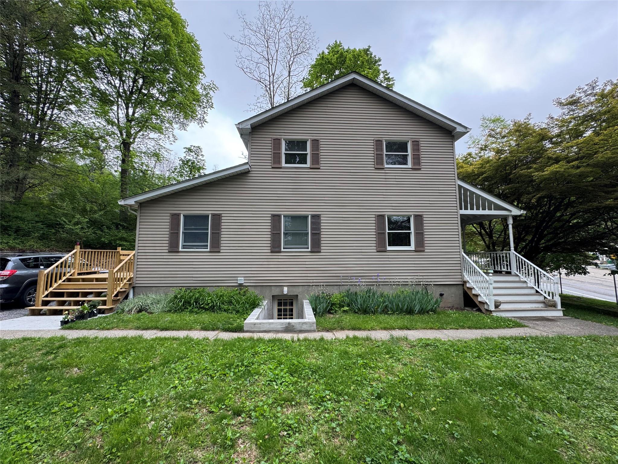 a front view of a house with a garden